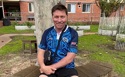 Stephen Owens sitting on the bench in the park
