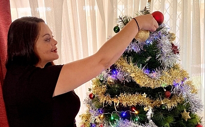 Tamara decorating a Christmas tree