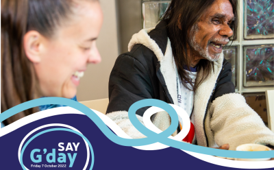 Two people laughing, with a graphic underneath the photo that says "say G'day: Saying G'day doesn't cost a thing. But it can bring change."